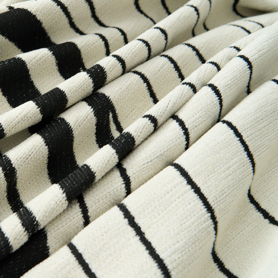 Macro of the Monochrome Wave woven fabric showing rippling black lines on cream