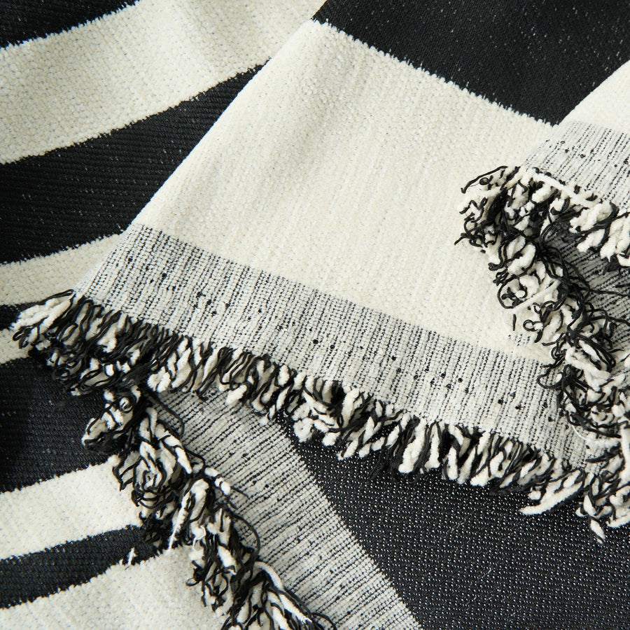 Close-up of the fringed corner of the Modern Wave Monochrome Wave throw