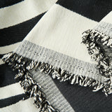 Close-up of the fringed corner of the Modern Wave Monochrome Wave throw