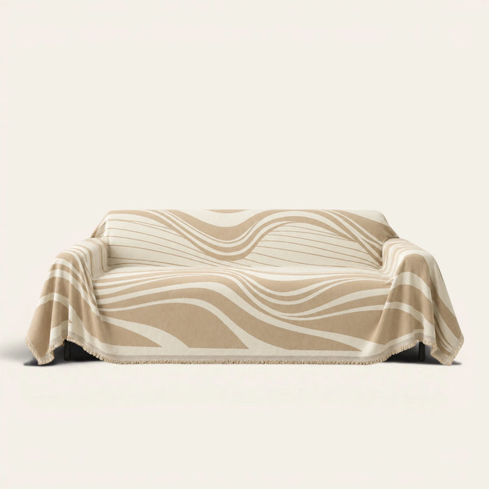 Sandy Drift Modern Wave throw draped over a two-seat sofa on ivory background