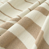 Macro of the woven wave fabric showing sandy tan and cream flowing lines