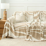 Sandy drift wave throw over a sofa with boucle cushion beside a panelled wall