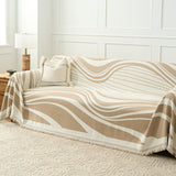 Modern wave throw styled across a sofa with boucle cushion and lamp