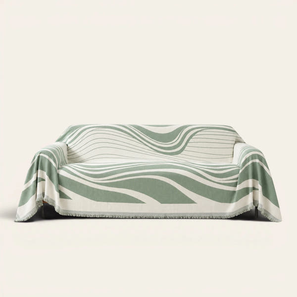 Verdant Flow Modern Wave sofa throw draped over a full couch, front view on ivory background