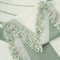 Close-up of the Verdant Flow Modern Wave throw showing fringed edge and woven wave pattern