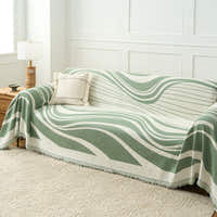 Verdant Flow Modern Wave throw over a full sofa with cushion and lamp in a bright room