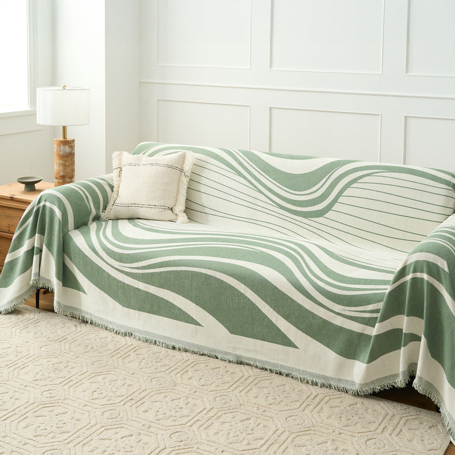 Verdant Flow Modern Wave throw over a full sofa with cushion and lamp in a bright room