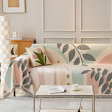 Garden arch Natural Botanical throw styled on a sofa with a tulip cushion in a bright living room