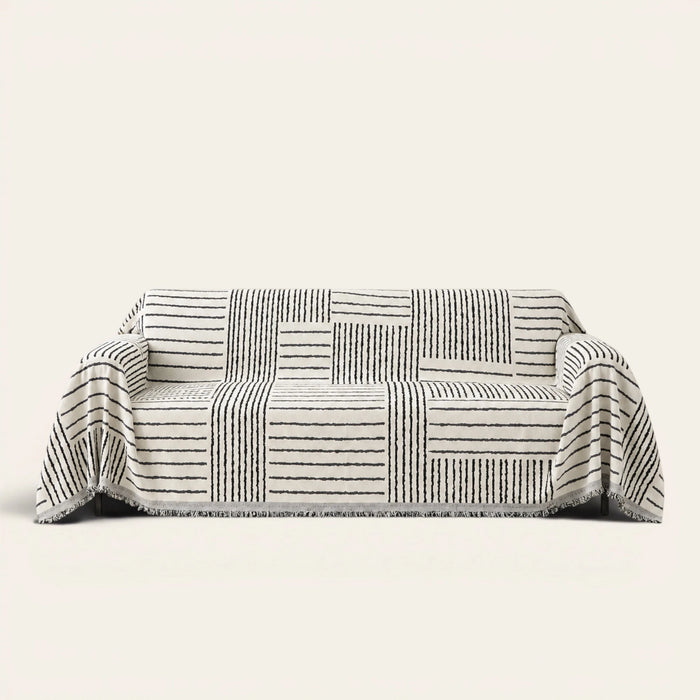 Sightline Stripes Monochrome Stripe sofa throw draped over a three-seat sofa, front view on ivory