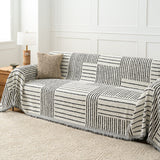 Monochrome Stripe Sightline Stripes throw covering a sofa, wide angled living room view