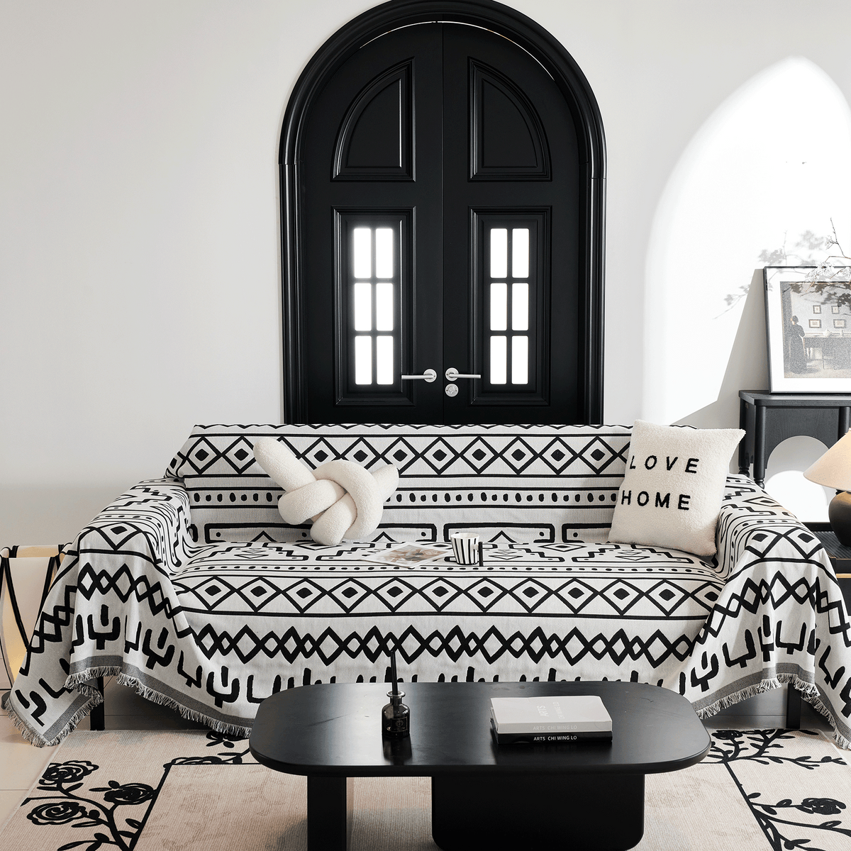 Black Bohemia Sleek Boho throw on a sofa by a black arched door with a knot cushion and coffee table
