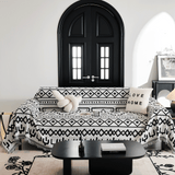 Black Bohemia Sleek Boho throw on a sofa by a black arched door with a knot cushion and coffee table