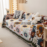 Ivory Blooms Sunflowers Fantasy throw draped over a sofa with pillows, three-quarter styled view