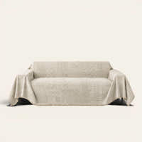 Sand Beige Textured Mosaic throw draped over a two-seat sofa on ivory background