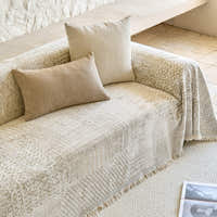 Sand beige mosaic throw on a sofa seat with beige lumbar and square cushions
