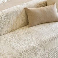 Close-up of the sofa back with beige lumbar cushion and mosaic jacquard weave