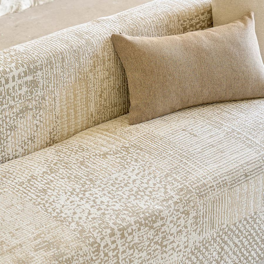 Close-up of the sofa back with beige lumbar cushion and mosaic jacquard weave