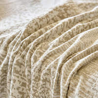 Macro of the sand beige fabric folds showing the tonal mosaic pattern