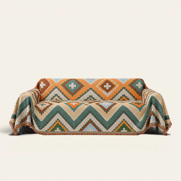 Rust Green Tribal Charm throw draped over a two-seat sofa on ivory background