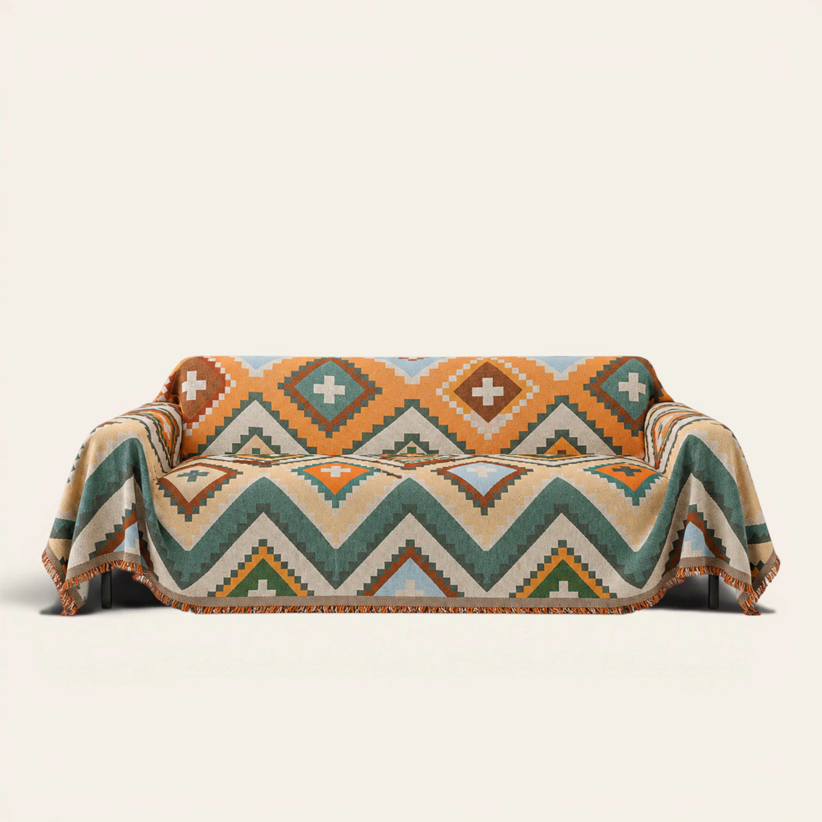 Rust Green Tribal Charm throw draped over a two-seat sofa on ivory background