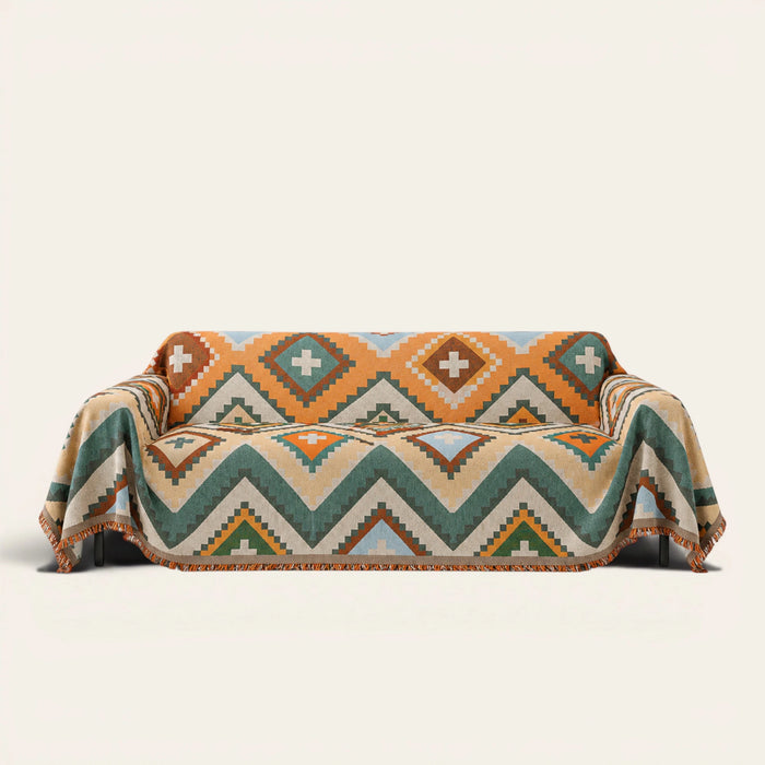 Rust Green Tribal Charm throw draped over a two-seat sofa on ivory background