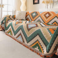 Tribal charm throw covering an L-shaped sofa with white cushion near a bright window